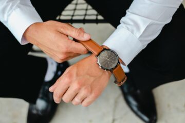 close up of bridegroom putting on watch