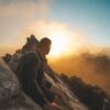 man wearing black long sleeved shirt standing on mountain