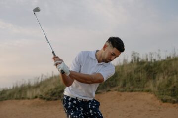 a man holding a golf club