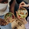 man and woman eating healthy food