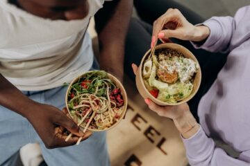 man and woman eating healthy food