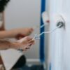 two people painting the wall