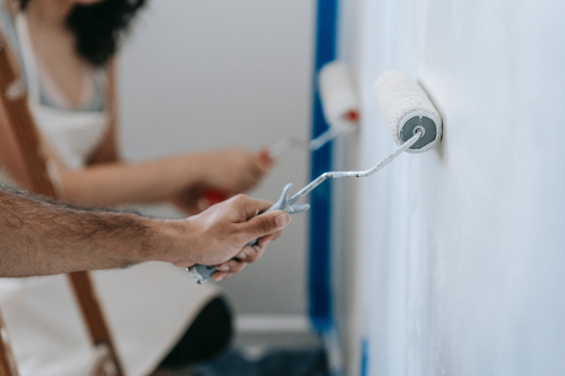 two people painting the wall