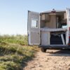 white and brown camper trailer on brown field