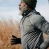 black man in sportswear jogging in sunny autumn day