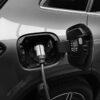 monochrome photo of hybrid car charging