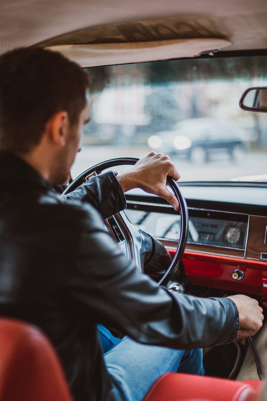 man driving vintage car